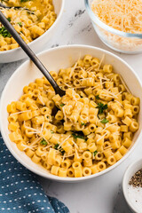 Steaming Parmesan soup garnished with parsley and grated cheese