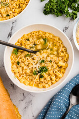 Parmesan pasta soup with parsley, perfect for winter comfort