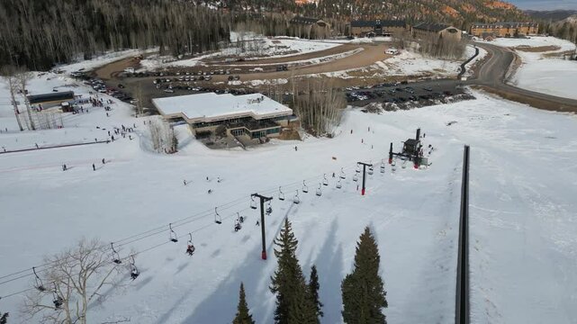 Ski lift and lodge at Brian Head Resort on snowy winter day in Utah, Aerial