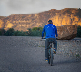mallor man on bicycle and blue jacket