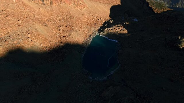 Predaccio, Valmalenco, Lombardy, Italy - A Stunning Turquoise Lake Nestled Within a Rugged Mountainous Landscape - Aerial Drone Shot