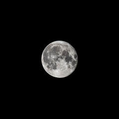 Detailed image of the full moon isolated on black.
