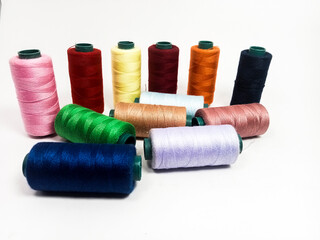 nylon sewing thread in roll form, various colors of sewing thread isolated on white background, suitable for textile industry product catalog design