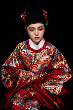 Young woman wearing Ming Dynasty Feiyu clothing on black background