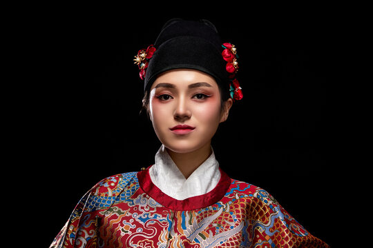 Young woman wearing Ming Dynasty Feiyu clothing on black background
