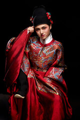 Young woman wearing Ming Dynasty Feiyu clothing on black background