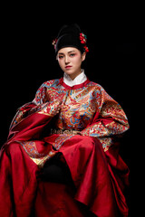 Young woman wearing Ming Dynasty Feiyu clothing on black background