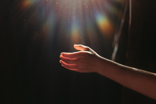 Hand reaching for Sunlight with rainbow flare - Powered by Adobe