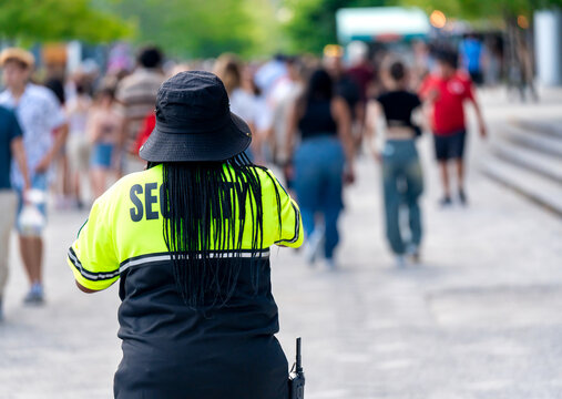 Security officer controlling crowd of people