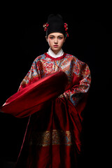 Young woman wearing Ming Dynasty Feiyu clothing on black background