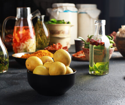 lemon bowl with spices & oils Ready to Cook, Pickle ingredient on dark background, banner, menu, recipe, top view.