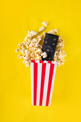 Paper bowl cups of popcorn with TV remote