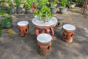 Round Marble Table and Chair Set in Artificial Garden on Concrete Floor