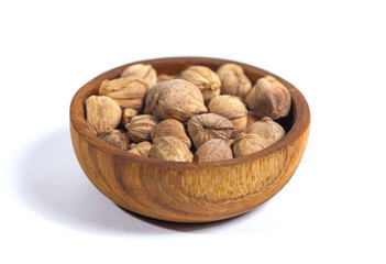 A bunch of cardamom (kapulaga) seeds isolated on a white background. In addition to being a flavor enhancer, cardamom is also used as a medicine for coughs, itchy throats, stomach aches, bloating.