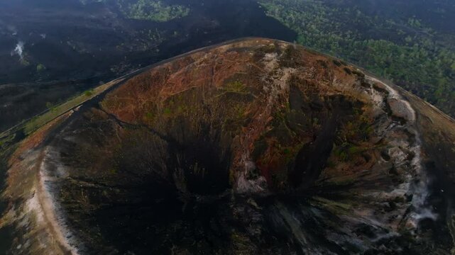 Approaching shot over Paricutin Volcanic crater reveals volcanic cone with cooled lava fields. Top down drone aerial