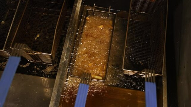 Fast Food Restaurant Deep Frying French Fries in Oil, Slow Motion