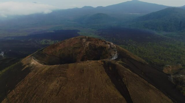 Aerial view of Paricutin Volcano's crater hole with dry lava fields in the valley showing eruption aftermath, Michoacan, Mexico