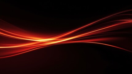Abstract orange light trails flowing on black background