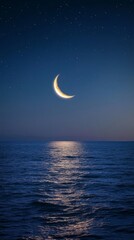 Serene crescent moonlit sky over tranquil ocean at night