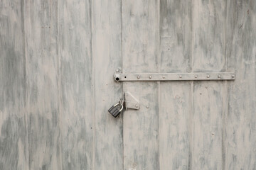 Old rusty padlock on the metal door