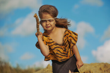 Cute baby dressed in the clothes of primitive people