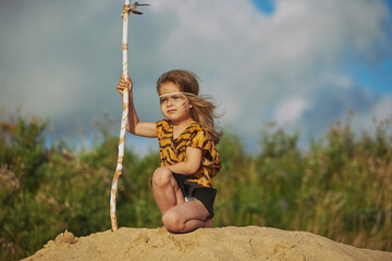Cute baby dressed in the clothes of primitive people
