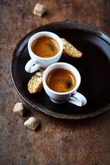Cantuccini (Italian cookie) and Two Cups Of Coffee on rustic stone background. Copy space.
