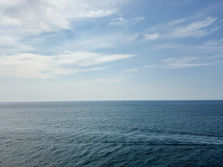 Open sea calm water and sky clouds horizon.