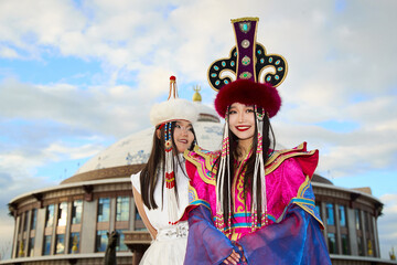Two Mongolian girls wearing traditional Mongolian tribal costumes