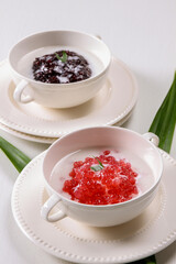 Traditional Indonesian sweet, bubur mutiara and black sticky rice simmered in a creamy coconut milk in isolated white background