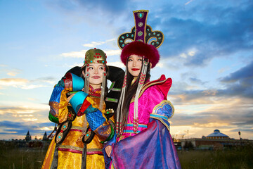 Two Mongolian girls wearing traditional Mongolian tribal costumes