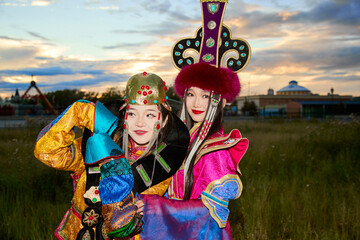 Two Mongolian girls wearing traditional Mongolian tribal costumes