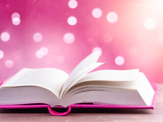 Open Book on Pink Bokeh Background