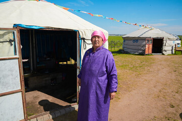 Middle-aged and elderly Mongolian women standing in front of a yurt