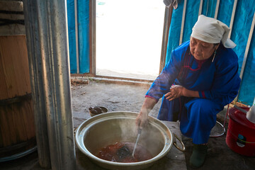 The process of brewing Mongolian milk tea using traditional techniques in a yurt