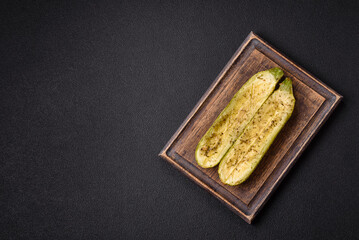 Delicious zucchini cut into two halves baked with salt, spices and herbs