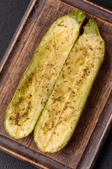Delicious zucchini cut into two halves baked with salt, spices and herbs