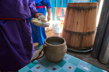 The process of distilling milk wine using traditional techniques in a yurt