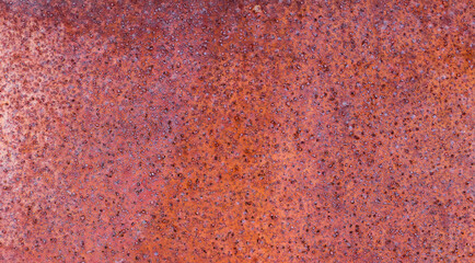 The rusty iron surface is old and rough.