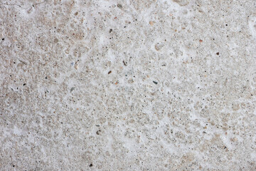 Gray concrete wall artificial building material with small holes