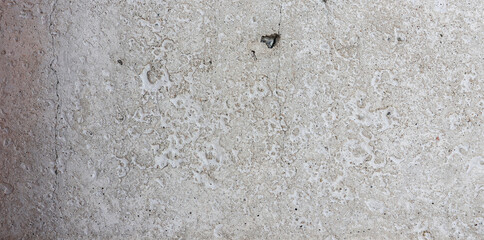 Gray concrete wall artificial building material with small holes