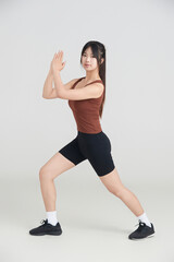 Obraz premium Asian woman doing exercise on white background