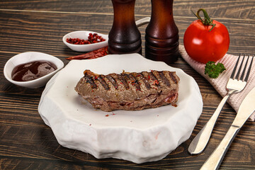 Grilled beef striploin steak with sauce