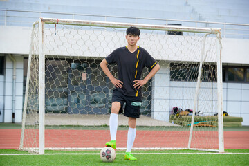 Athletes playing soccer on the outdoor football field