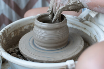 Making of mud pot on potters wheel during workshop in art ceramic atelier in Poland