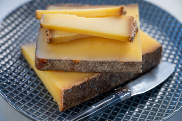 French cheese Comte, varieties unpasteurised ed milk Prestige, fruity flavoured Fruite and Vieille Reserve close up