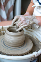 Making of mud pot on potters wheel during workshop in art ceramic atelier in Poland