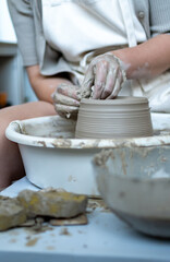 Making of mud pot on potters wheel during workshop in art ceramic atelier in Poland