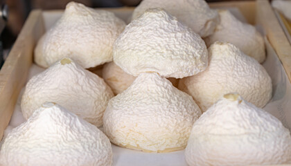 Cheese collection, French Meringue de Chevre pyramid cheese made from goat milk in region Tarn in France close up