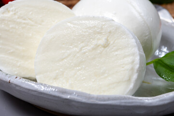 Tasty italian food, fresh white buffalo mozzarella soft cheese balls from Campania close up